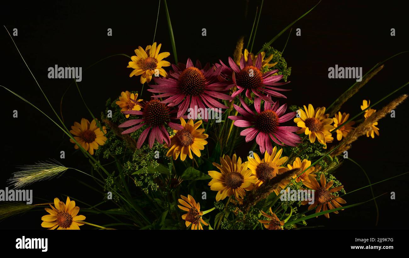 A bouquet of flowers collected in the wild in a simple glass vase ...