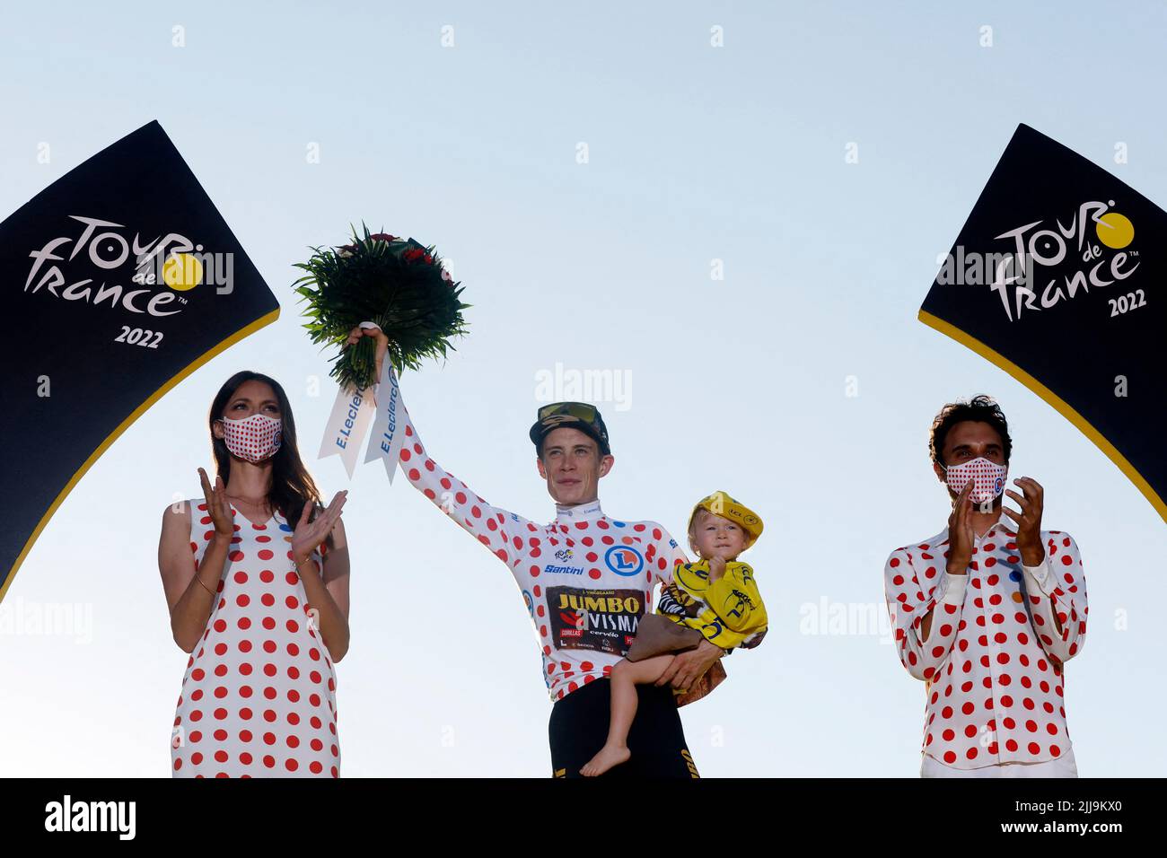 Cycling - Tour de France - Stage 21 - Paris La Defense Arena to Champs-Elysees - France - July 24, 2022 Jumbo - Visma's Jonas Vingegaard celebrates on the podium wearing the polka-dot jersey holding his daughter Frida after winning the Tour de France REUTERS/Gonzalo Fuentes Stock Photo