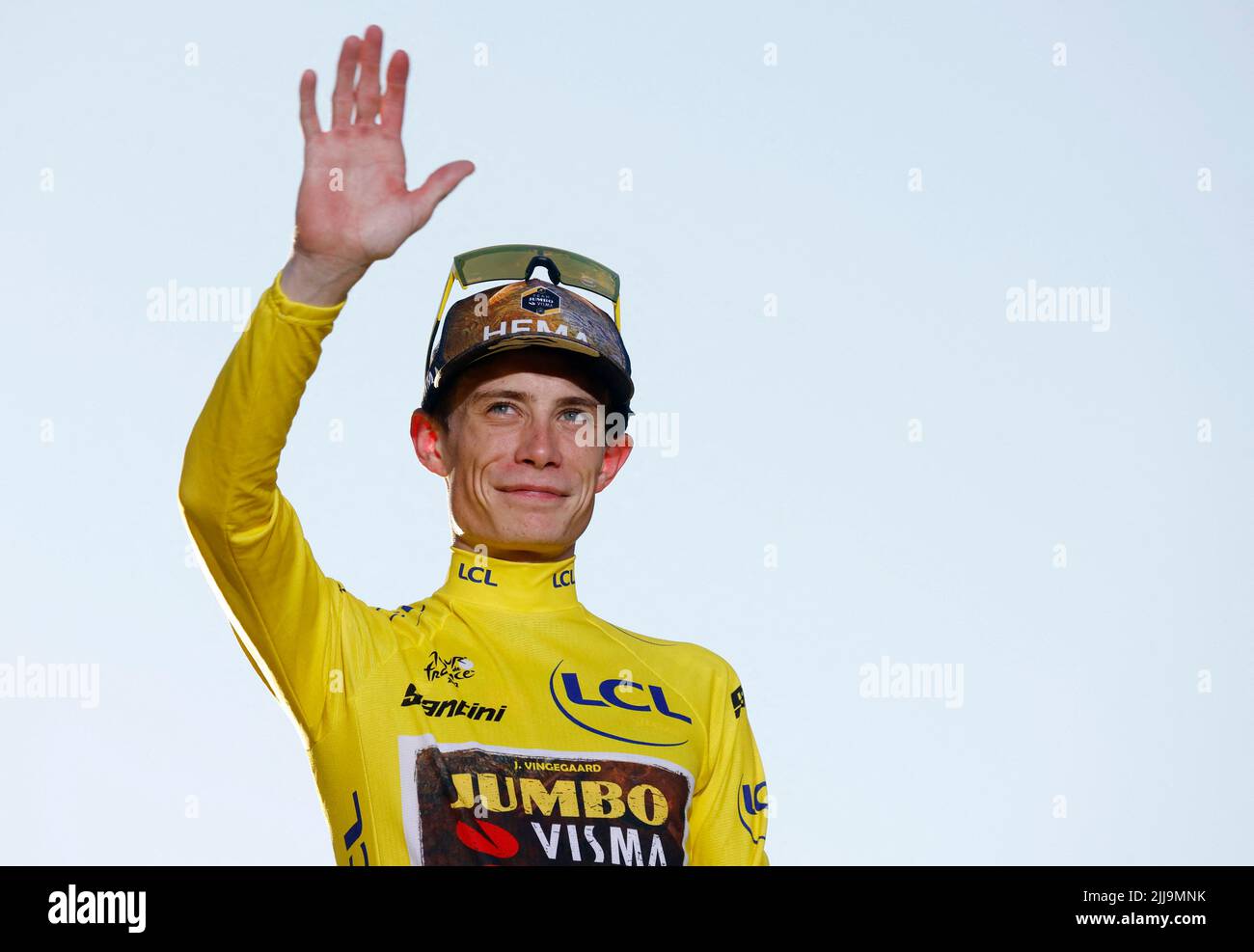 Cycling - Tour de France - Stage 21 - Paris La Defense Arena to Champs-Elysees - France - July 24, 2022 Jumbo - Visma's Jonas Vingegaard celebrates on the podium wearing the overall leader's yellow jersey after winning the Tour de France REUTERS/Gonzalo Fuentes Stock Photo