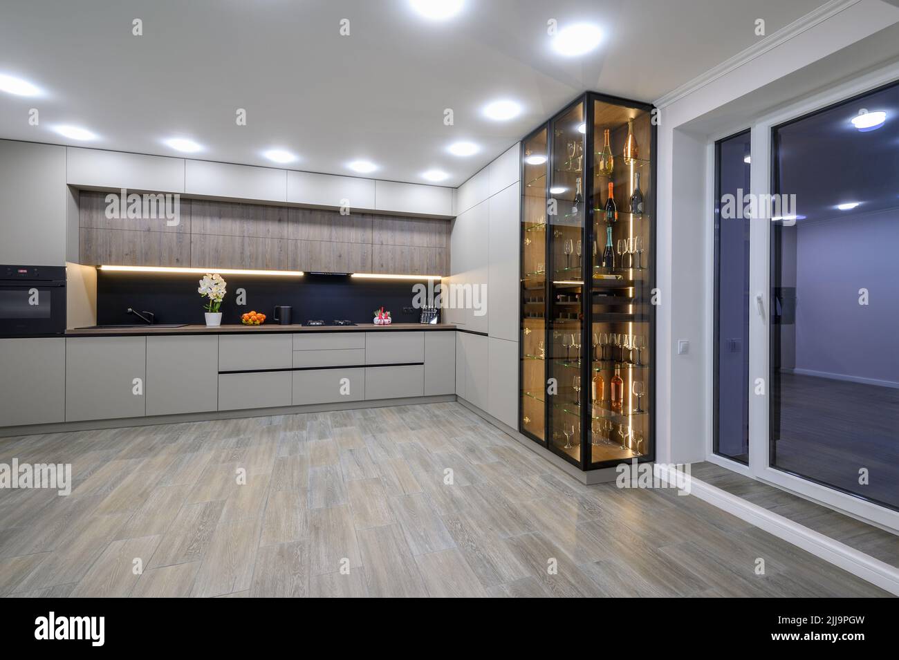 Trendy grey modern kitchen interior with minimalistic furniture Stock