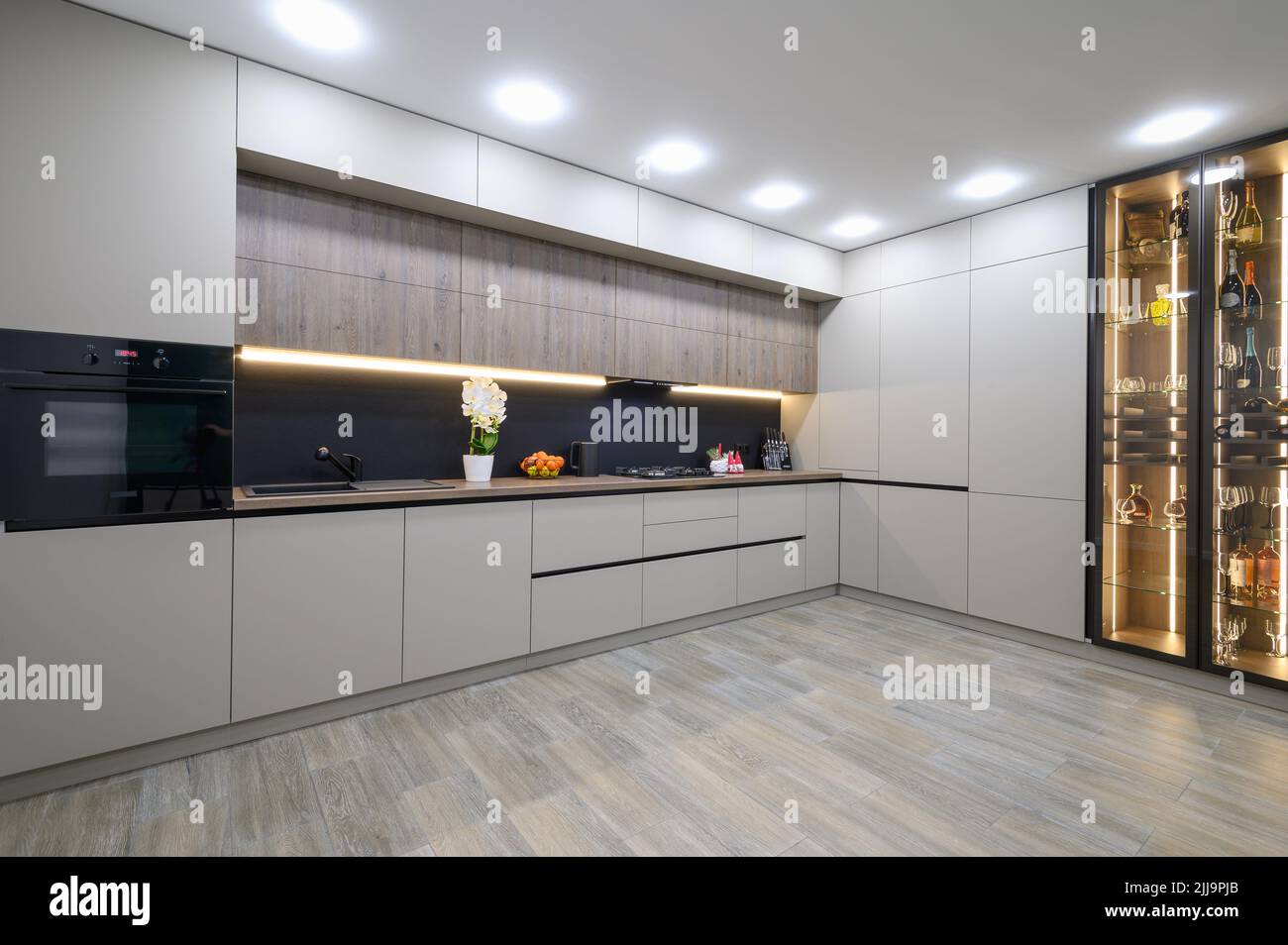 Trendy grey modern kitchen interior with minimalistic furniture Stock