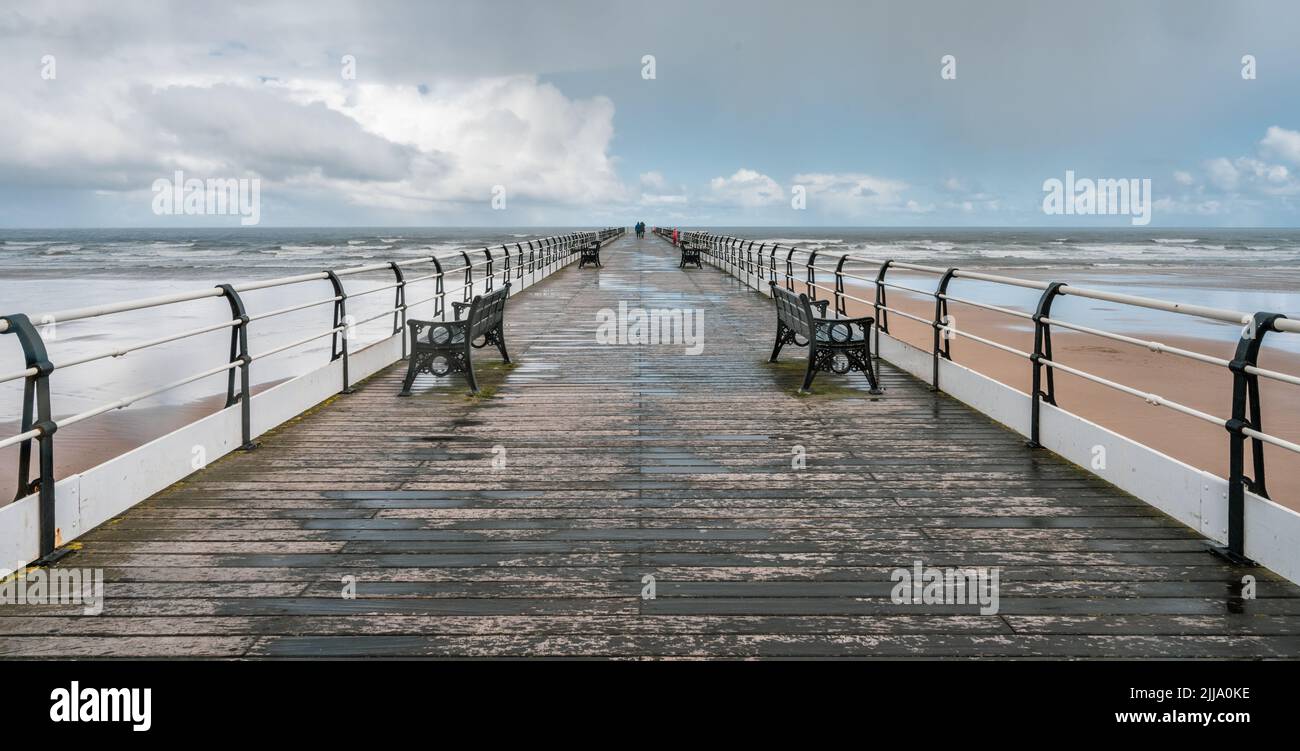 A long walk to the end of the pier on a blustery spring day Stock Photo