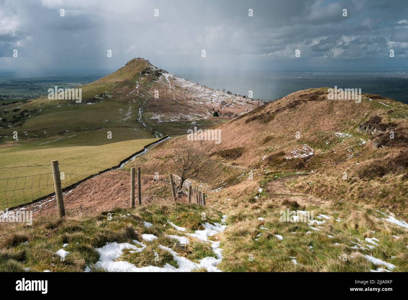 Roseberry Topping with a dusting of snow as a wintery squall passes by Stock Photo