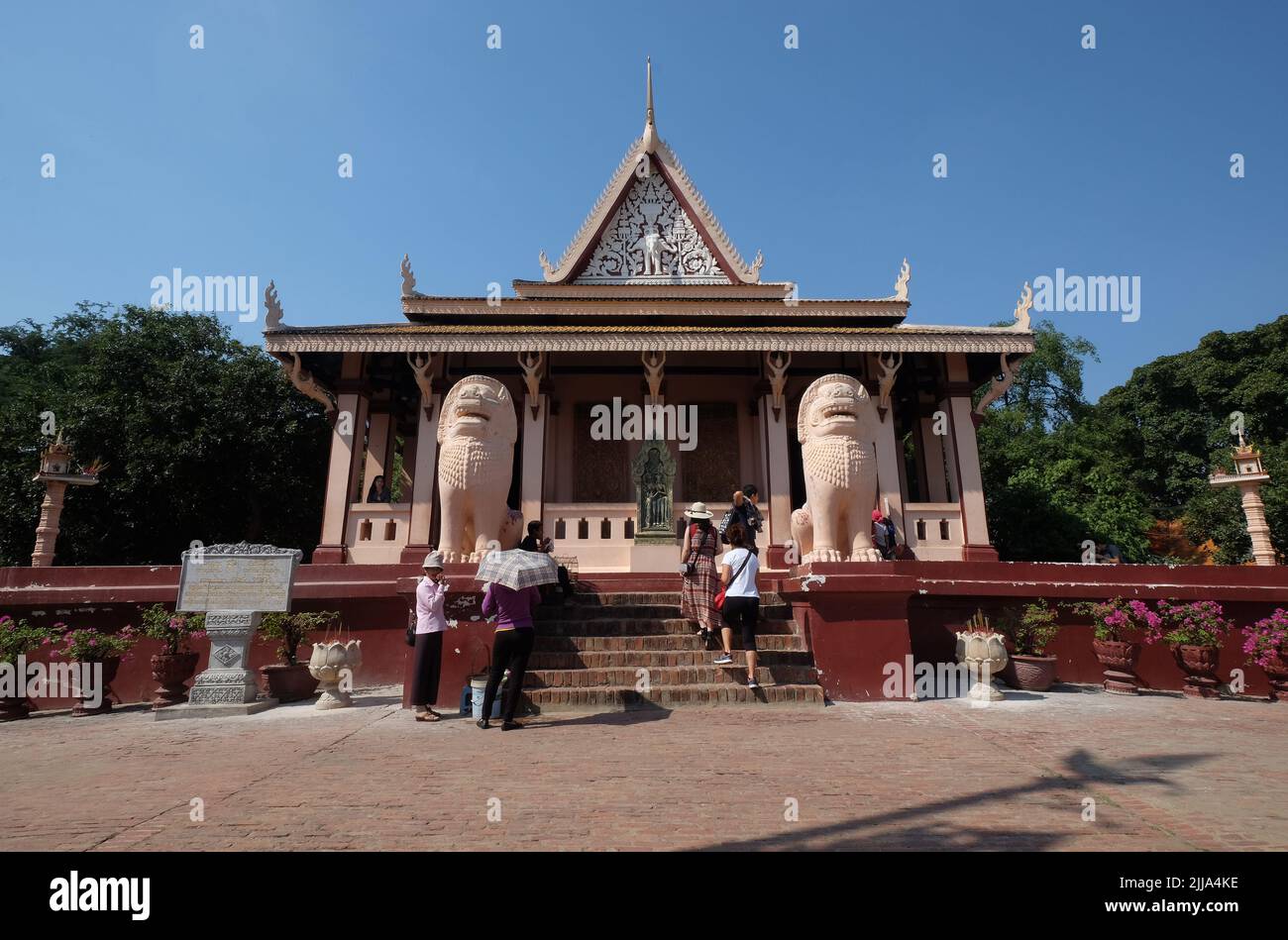 Tourists climb the stairs to enter the Wat Phnom Hill Buddhist temple, a pagoda in the capital city of Phnom Penh, Cambodia. Stock Photo