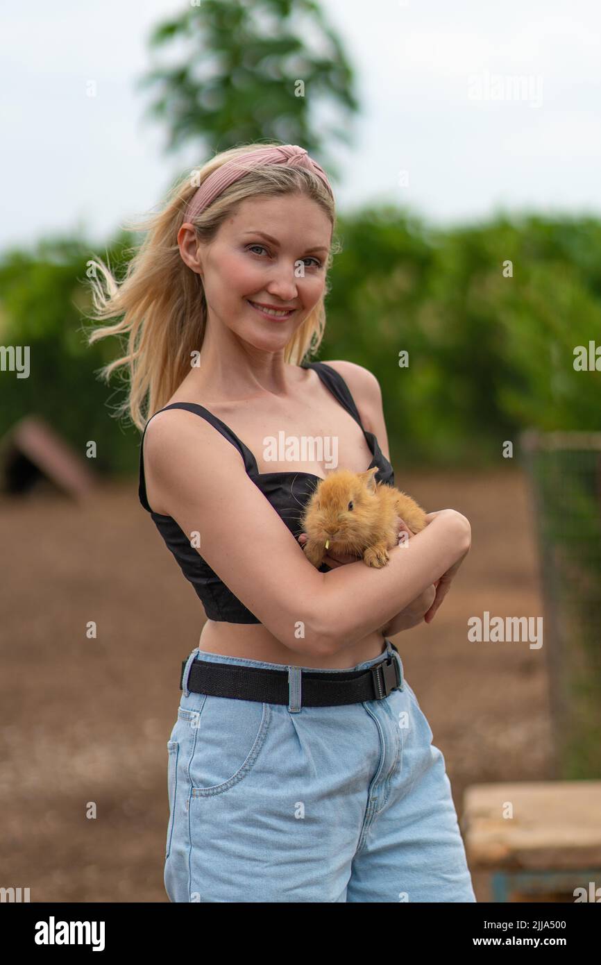 Rabbit girl holding bunny easter cute furry friendship attractive pet, for hands woman for pretty for farm domestic, outdoor adorable. Ears face, Stock Photo