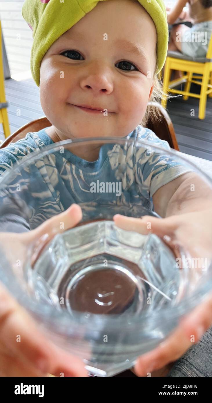 Portrait of a small girl holding a glass of water Stock Photo Alamy