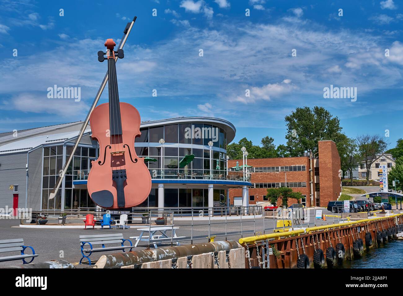 The world's largest fiddle is located on the waterfront in Sydney Nova Scotia.  Reaching a height of 60 feet, the landmark greets the many visitors wh Stock Photo