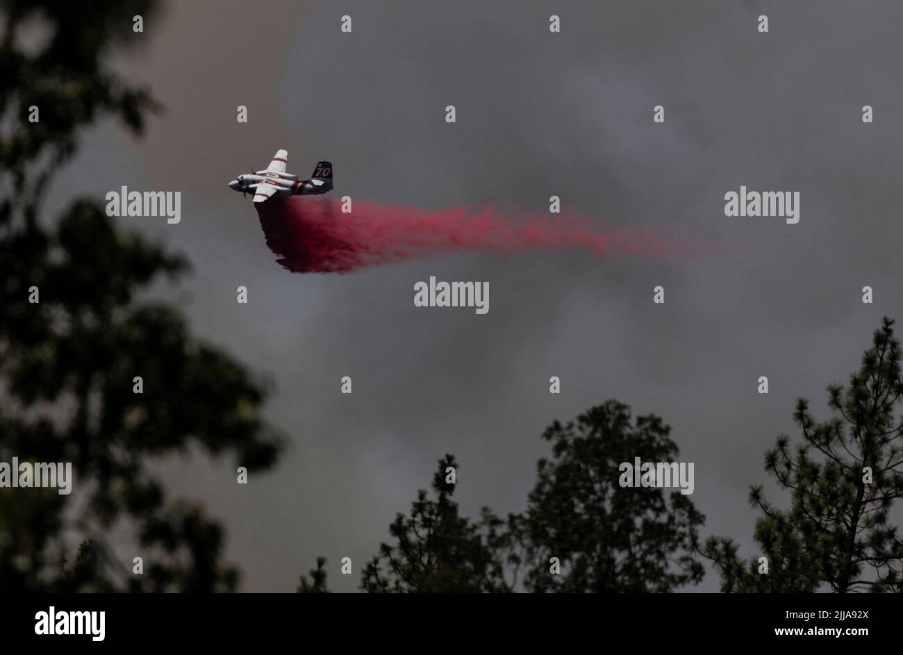 A firefighting aircraft drops flame retardant on a hillside to control the Oak Fire as it burns near Darrah in Mariposa County, California, U.S., July 24, 2022. REUTERS/Carlos Barria Stock Photo