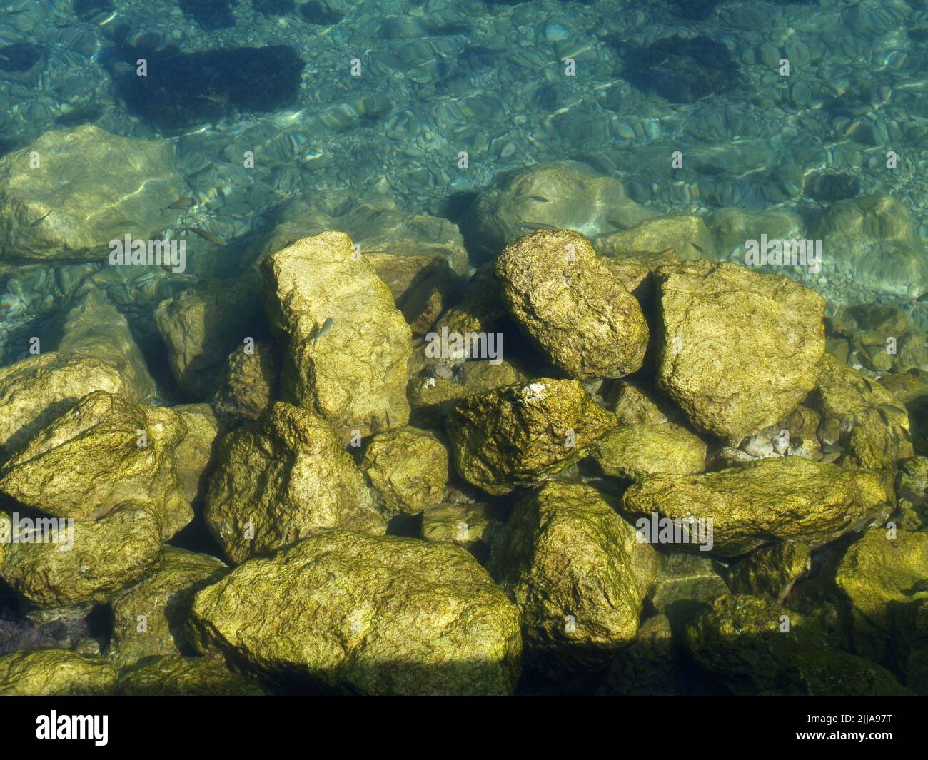 Pebbles on shoreline at Garitsa Bay, Corfu, Greece Stock Photo
