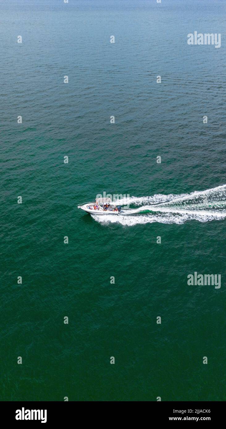 A vertical shot of a yacht sailing in the ocean Stock Photo - Alamy