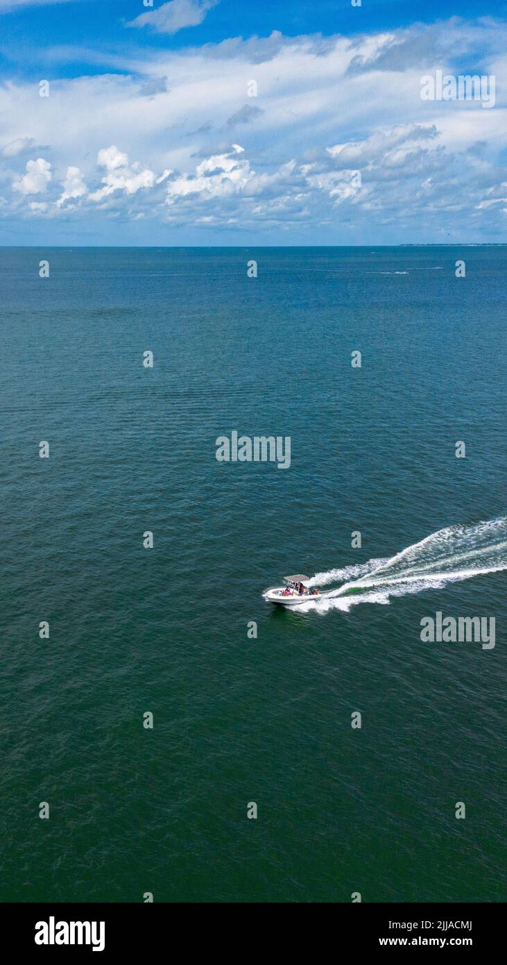 A vertical shot of a yacht sailing in the ocean Stock Photo - Alamy