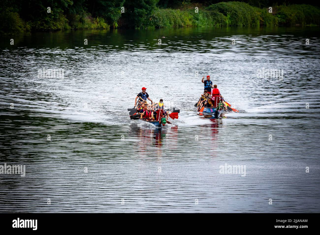 Two Dragon Boats racing along the River Mersey Stock Photo