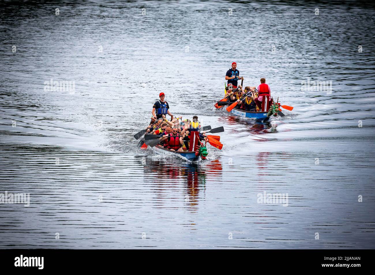 Two Dragon Boats racing along the River Mersey Stock Photo