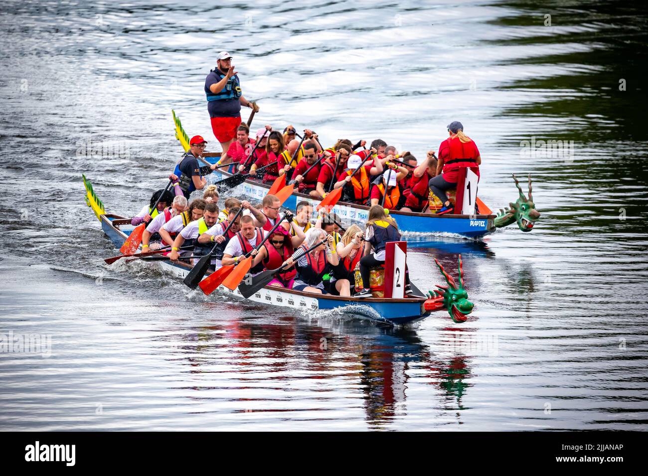 Two Dragon Boats racing along the River Mersey Stock Photo