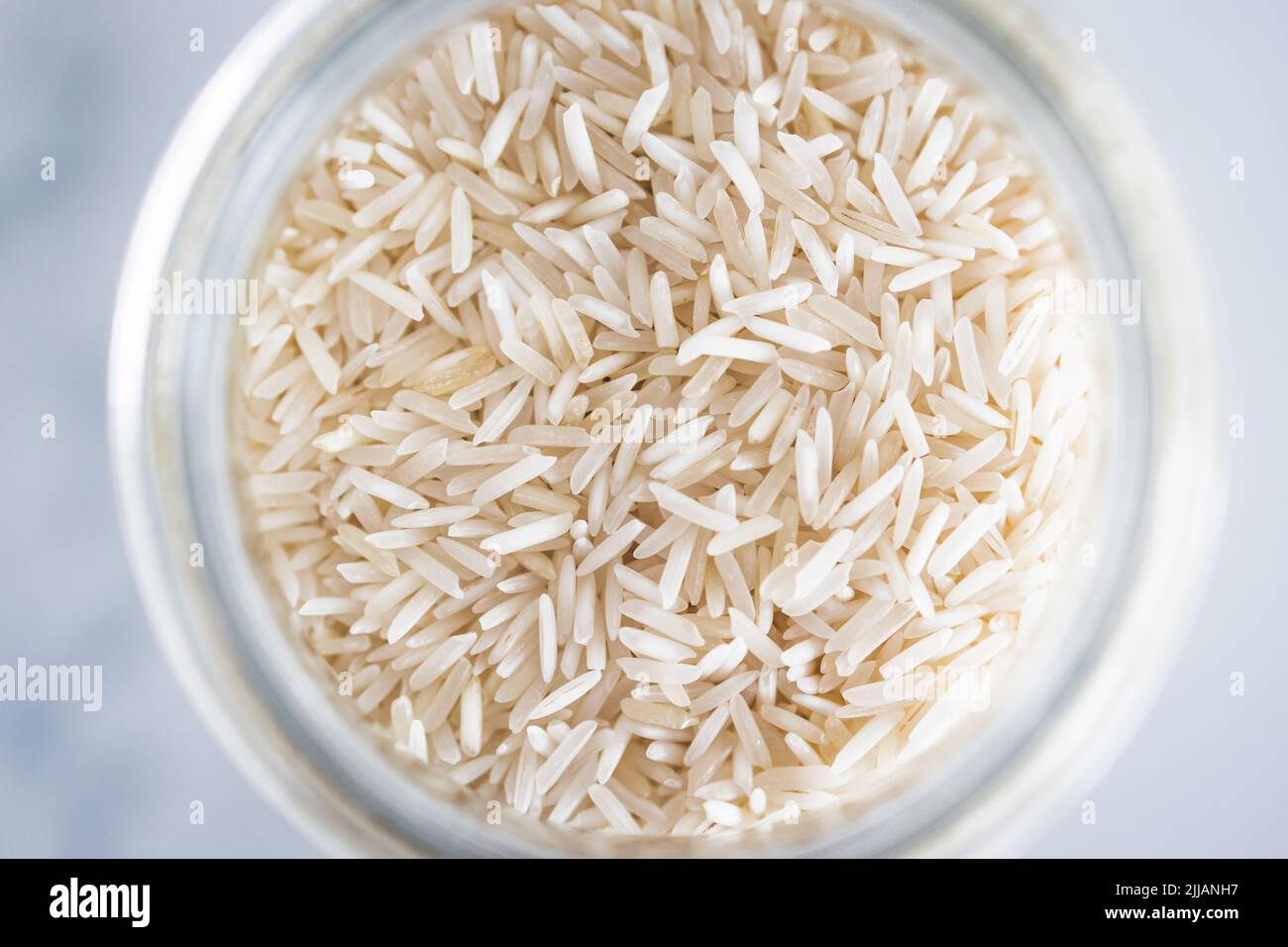 glass jar with basmati rice close-up shot from top down perspective ...