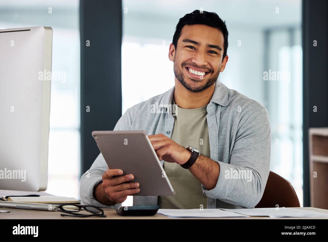 No one could do what I do. a young businessman using his digital tablet. Stock Photo