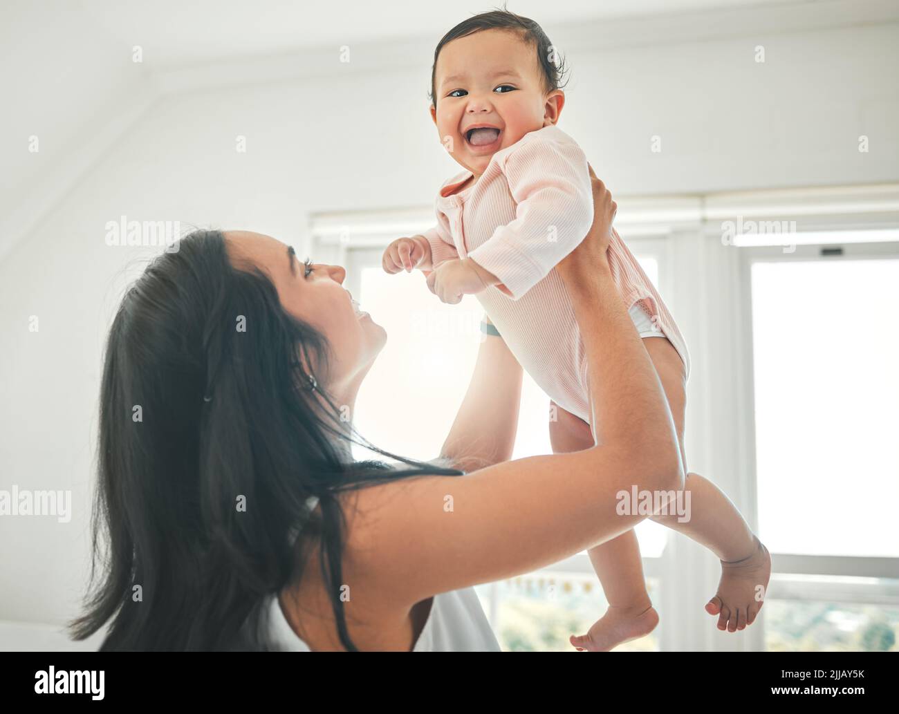 Youve given me even more reason to smile. an attractive young woman and her newborn baby at home. Stock Photo