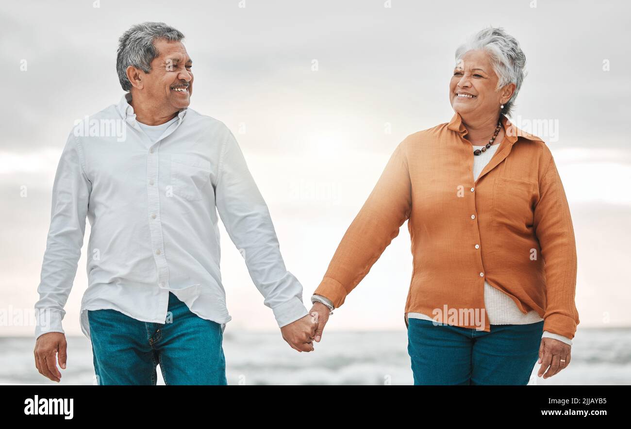 Romance never dies. an affectionate senior couple sharing an intimate moment on the beach. Stock Photo