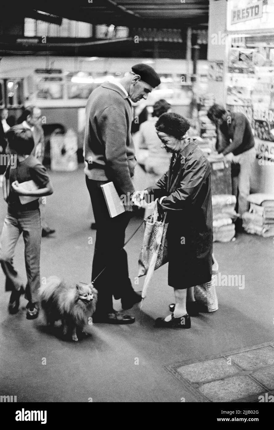 Two esidents of Sydney's Kings Cross stop to converse on the night streets of this bustling inner city area know for its strip clubs and secx shows. Circa 1977 Stock Photo