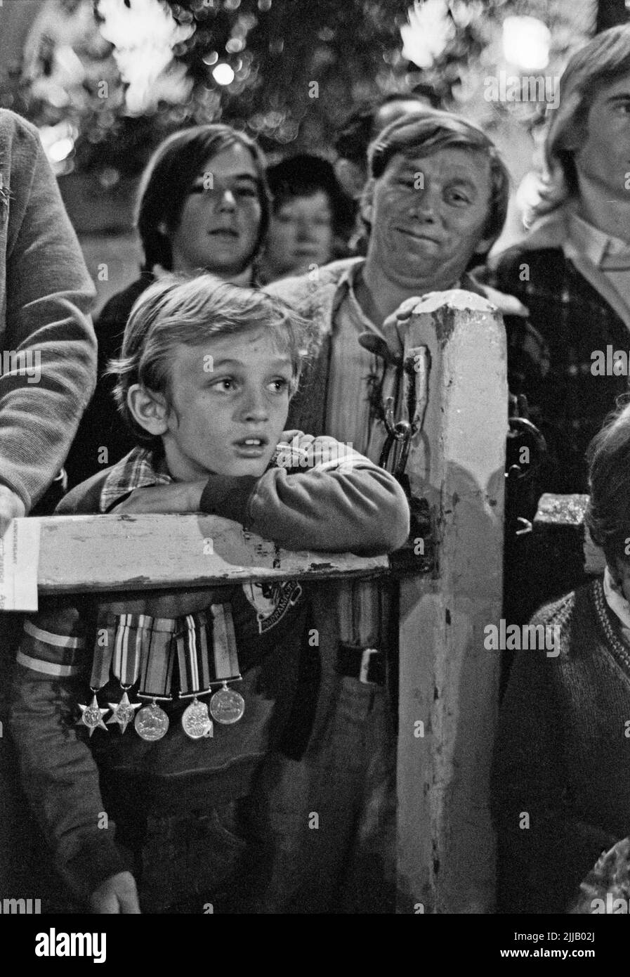 Young boy wearing his father's or his grandfather's medals at the Anzac Day dawn service in Sydney's Martin Place, April 25, 1980. Stock Photo