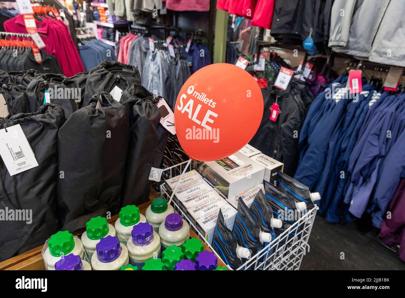 Millets outdoor clothing store interior, balloon advertises sale prices on outdoor clothing including jackets and pants,Bury,Uk summer 2022 Stock Photo