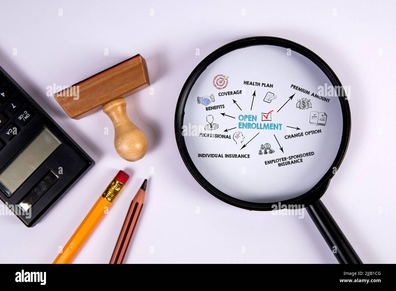 Open Enrollment concept. Magnifying glass on office desk. Stock Photo