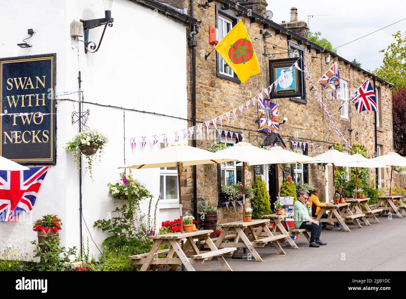 British pub, The Swan with Two Necks in Pendleton Lancashire, union jacks and bunting to celebrate Queen Elizabeth platinum ,Lancashire,England Stock Photo