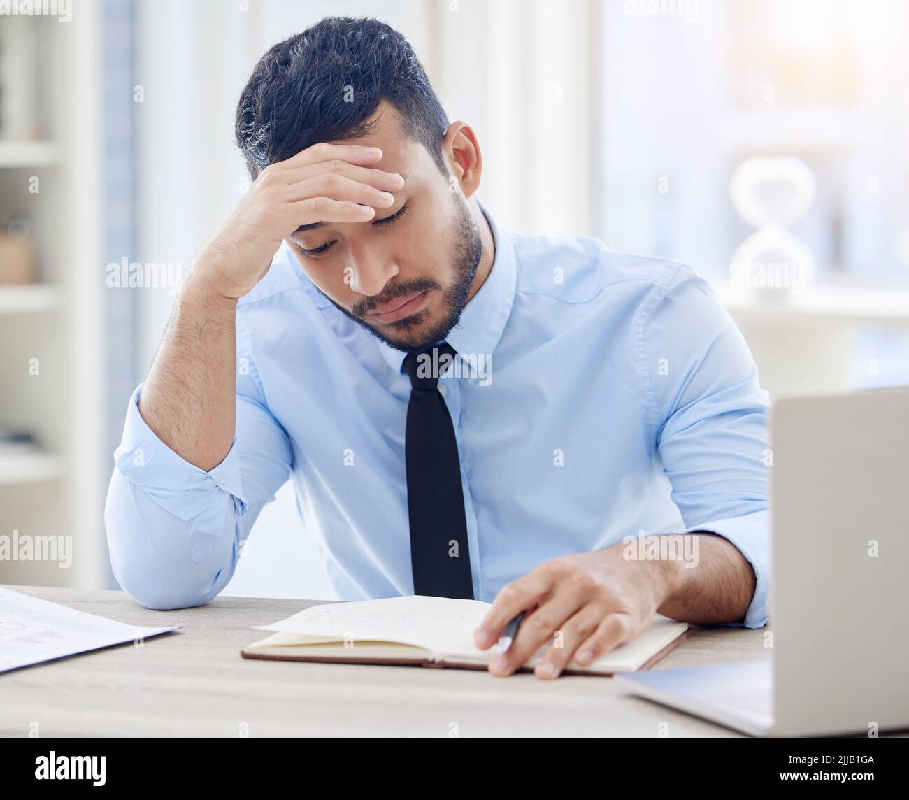 Youll never make it in this environment. a young businessman looking stressed at work. Stock Photo