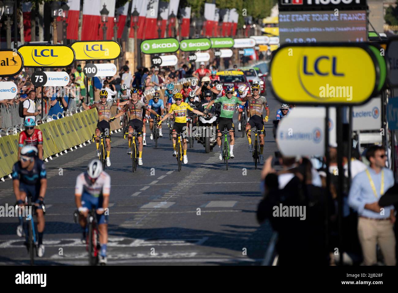 Paris, France, 24/07/2022, Jumbo-Visma teamDanish rider Jonas Vingegaard wearing the overall leader's yellow jersey (2-L)celebrates flanked by his teammate Jumbo-Visma team's Belgian rider Wout Van Aert (2-R) wearing the sprinter's green jersey and Jumbo-Visma team's Belgian rider Tiesj Benoot (L) and Jumbo-Visma team's French rider Christophe Laporte as they crosses the finish line of the 109th edition of the Tour de France cycling race, after the 21st and final stage, 115,6 km between La Defense Arena in Nanterre, outside Paris, and the Champs-Elysees in Paris, France, on July 24, 2022. Phot Stock Photo