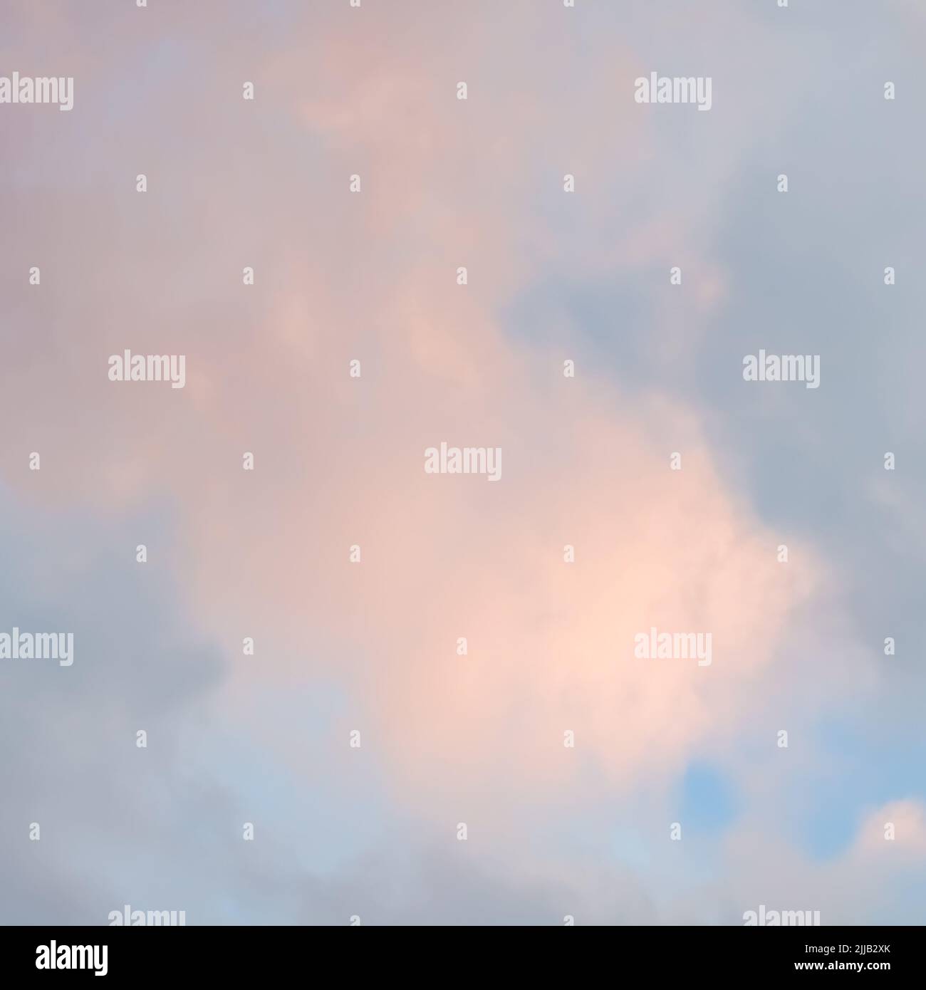 Background of blue sky with pale pink clouds at sunset Stock Photo - Alamy