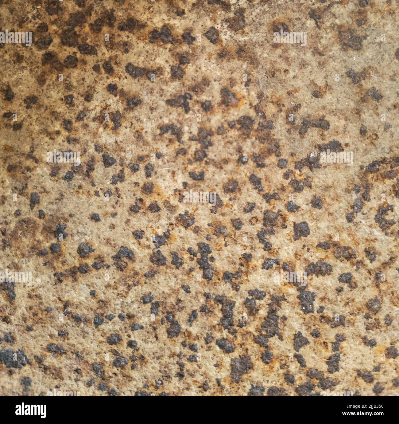 Rust on metal texture. Pattern dark black rusty spots on brown metal surface Stock Photo