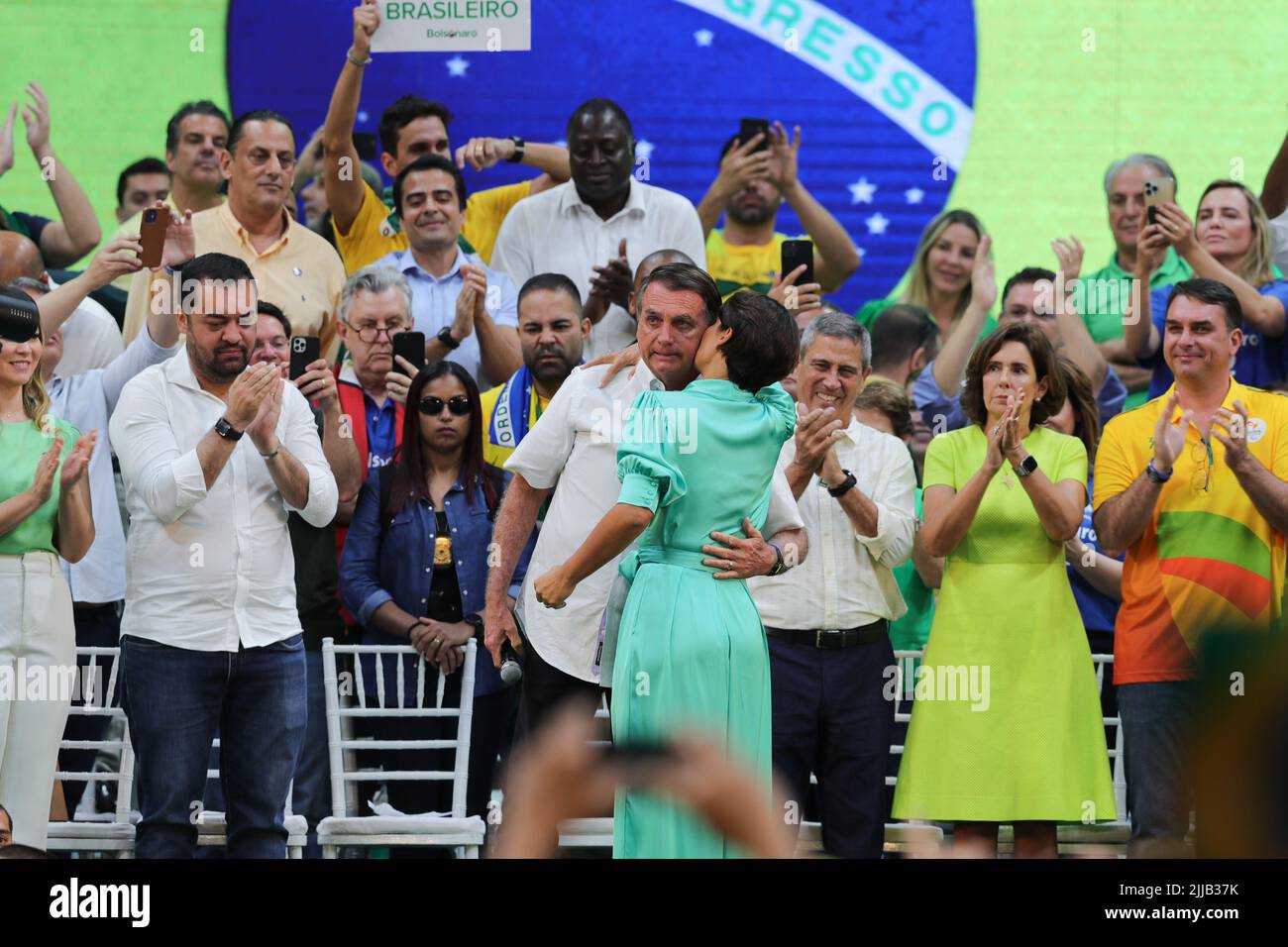 Rio De Janeiro, Brazil. 24th July, 2022. Brazilian President Jair Bolsonaro (C) hugs his wife Michelle Bolsonaro during an election rally in Rio de Janeiro, Brazil, on July 24, 2022. Brazilian President Jair Bolsonaro on Sunday officially announced his intent to seek re-election and named Walter Souza Braga Netto, the former Brazil's Minister of Defense, as his intended vice president. Credit: Wang Tiancong/Xinhua/Alamy Live News Stock Photo