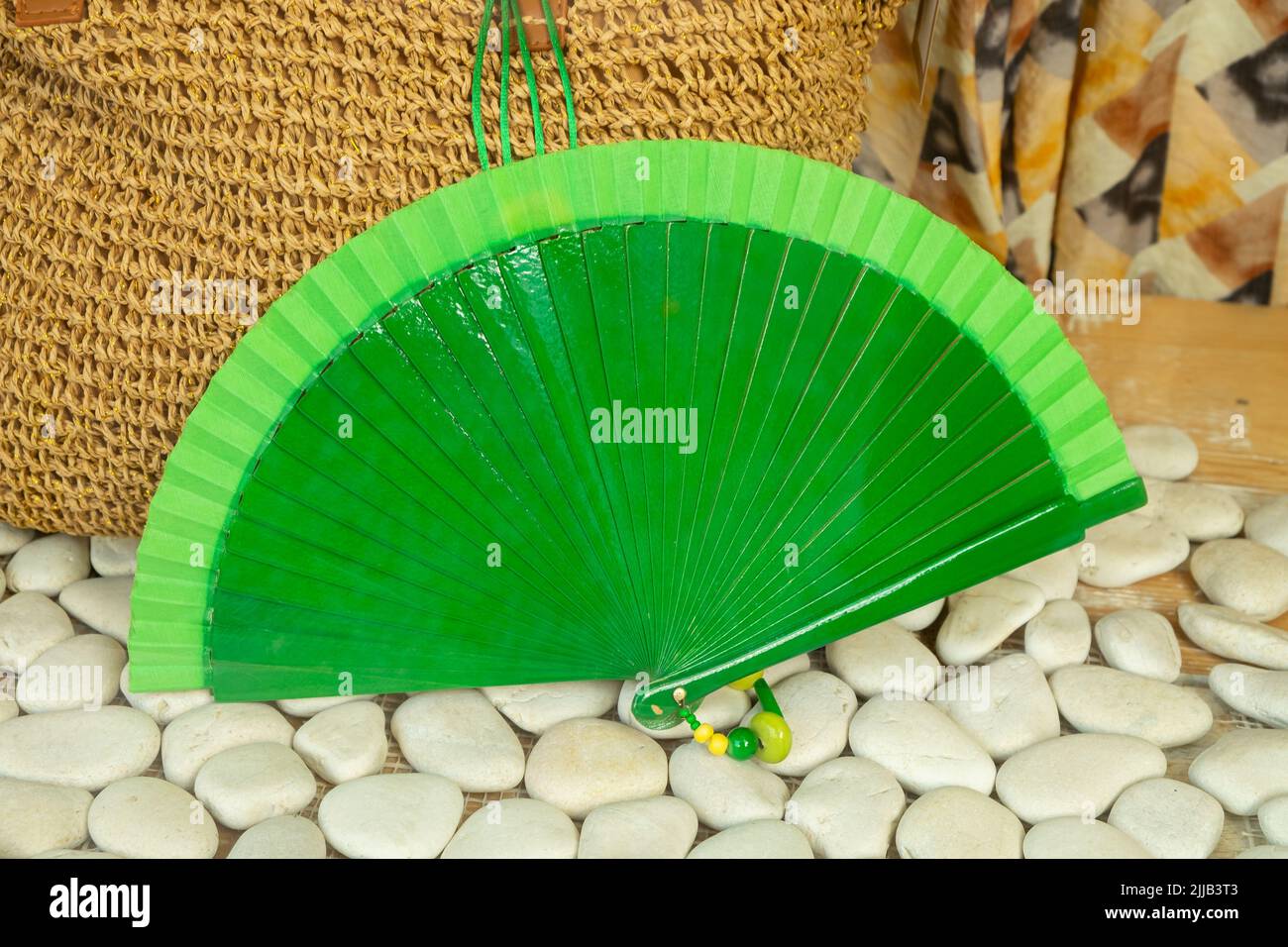 A fan in a store with a bag background of natural ropes and white ...
