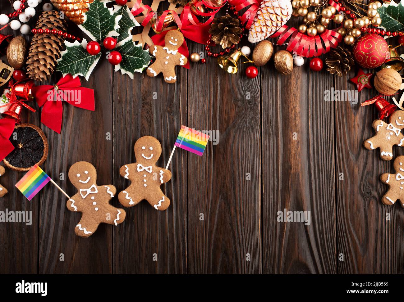Christmas background of gingerbread cookie men with rainbow flags on wooden table Stock Photo