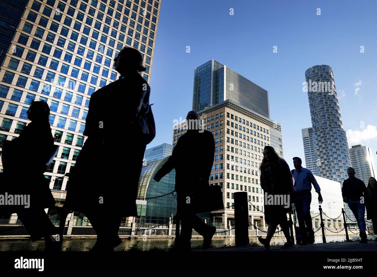 File photo dated 06/10/21 of office workers and commuters walking through Canary Wharf in London. Office attendance is up by a third compared to January, new data from workplace provider IWG shows. Issue date: Monday July 25, 2022. Stock Photo