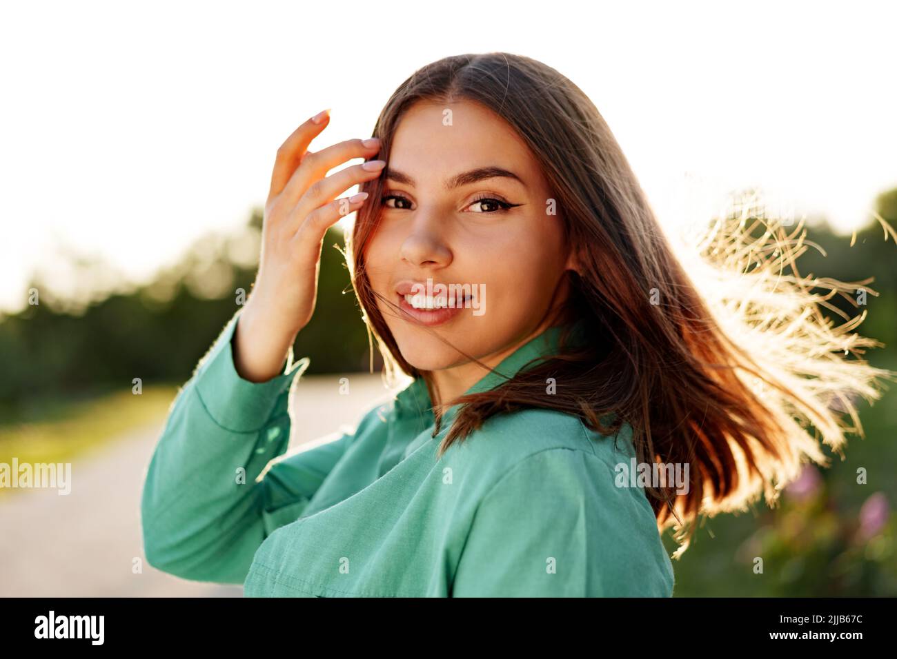 Close up portrait of a young smiling brunette woman Stock Photo - Alamy