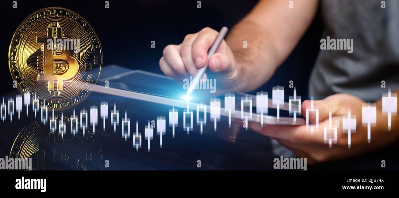 Man Bitcoin trading chart on the screen. Holding in hand a gold Bitcoin Cash  coin. Trading on the cryptocurrency exchange Stock Photo - Alamy