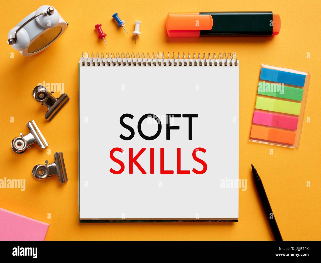 The word soft skills written on a notebook on business desktop table. People, communication, interaction, listening skills concept. Stock Photo