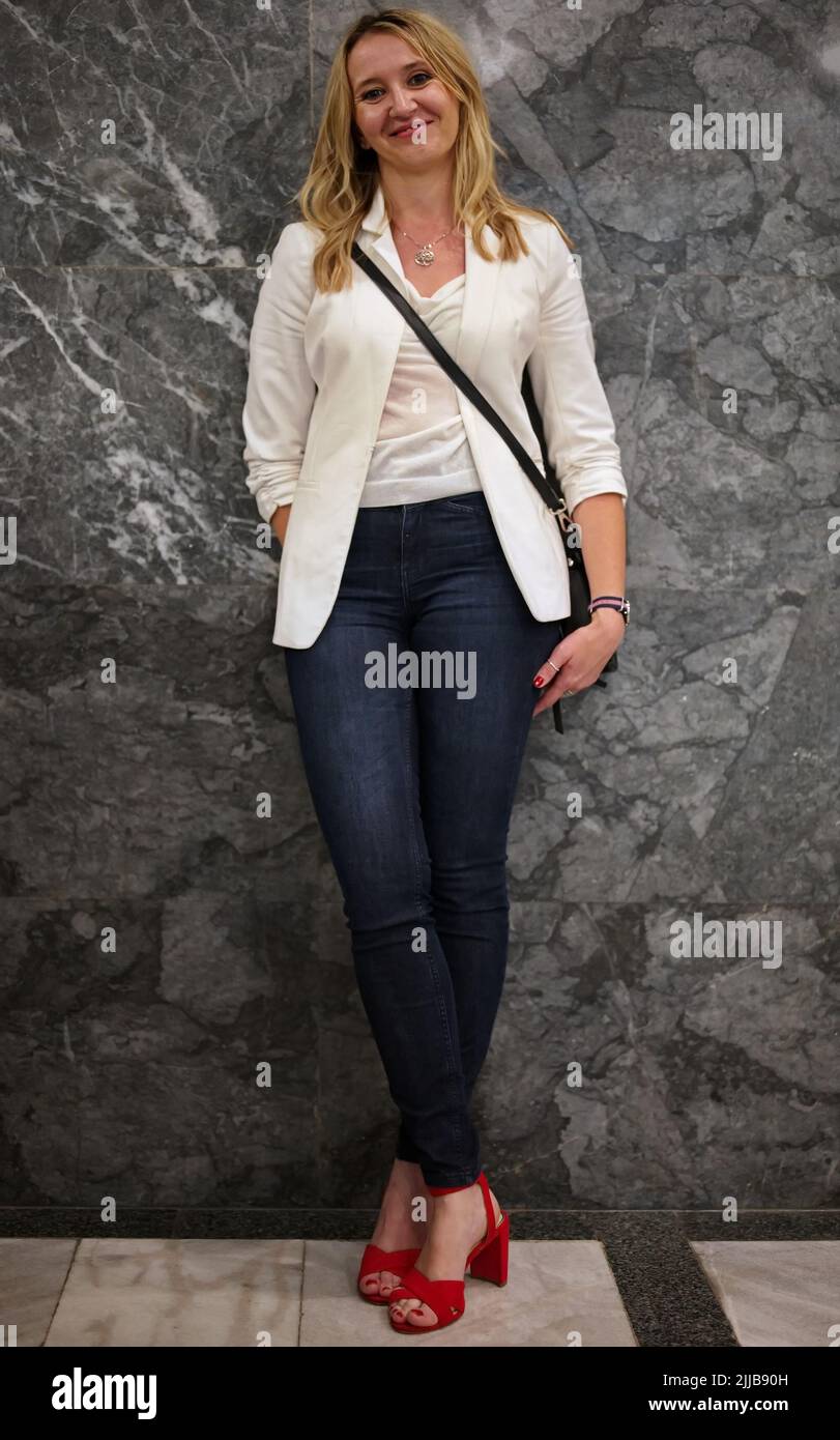 Beautiful blond mature woman standing against the wall Stock Photo