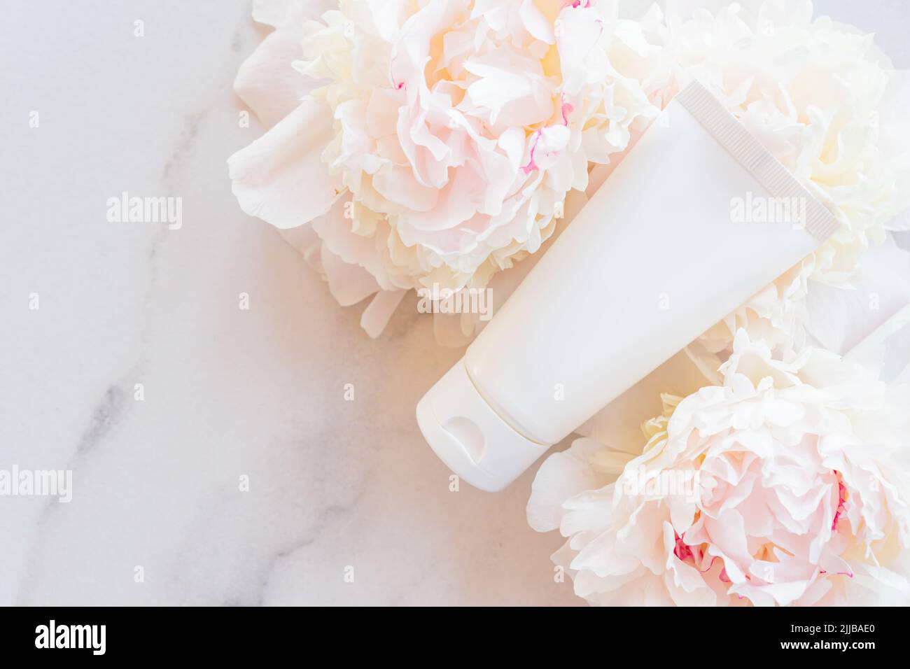 Premium Photo  Cosmetic skin care products with peony essential oil on  wooden tray on barble table unbranded cosmetics