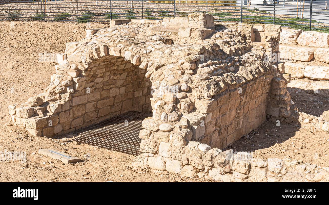 ruin of an Ottoman era waterwheel support over one of the seven mythical ancient Biblical wells in Beersheba in Israel Stock Photo
