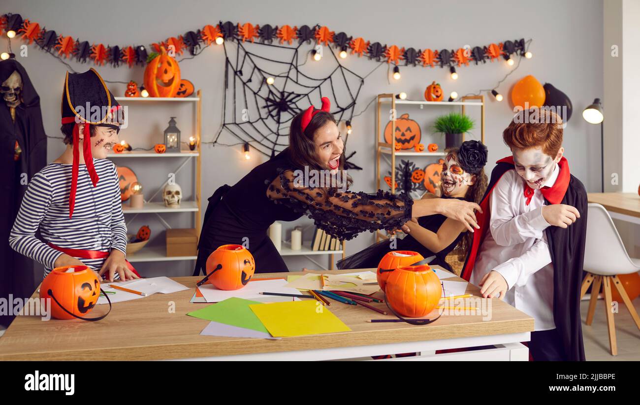 Happy teacher have fun with children on Halloween Stock Photo