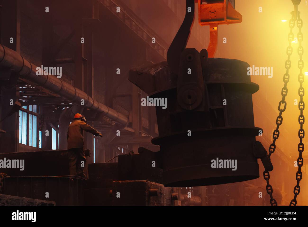 Foundry worker in metallurgy plant after iron cast, heavy industry. Stock Photo