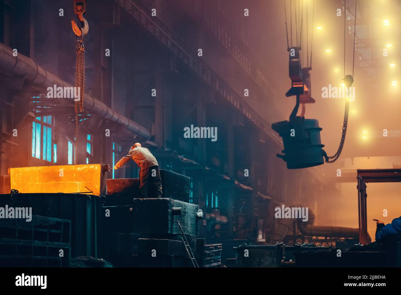 Metallurgy plant interior. Foundry worker on big mold for iron cast