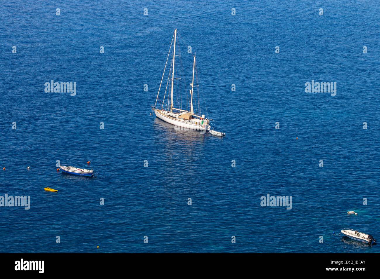 White sailboat resting in bay of Scilla, Calabria, Italy Stock Photo