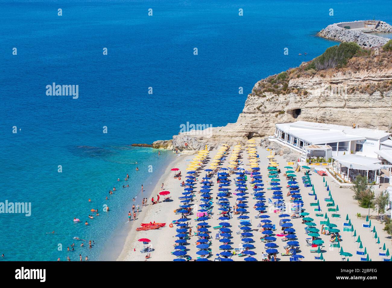 Beach at Tropea with umbrellas, Calabria, Italy Stock Photo