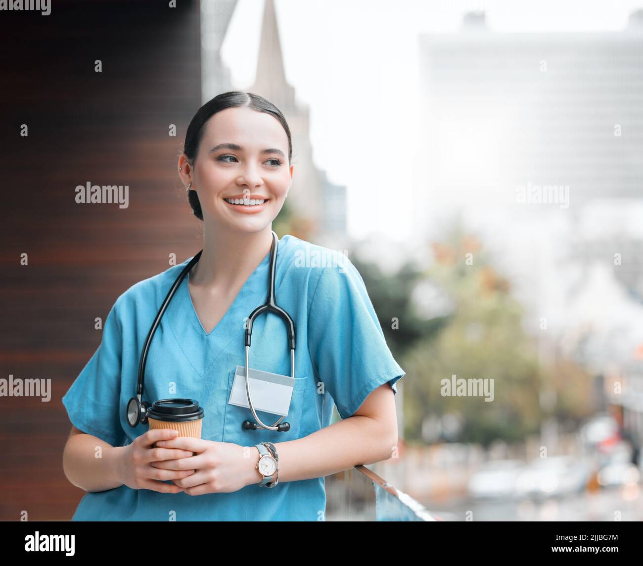 Every doctor needs their daily dose of caffeine. a young female doctor having a coffee at work. Stock Photo