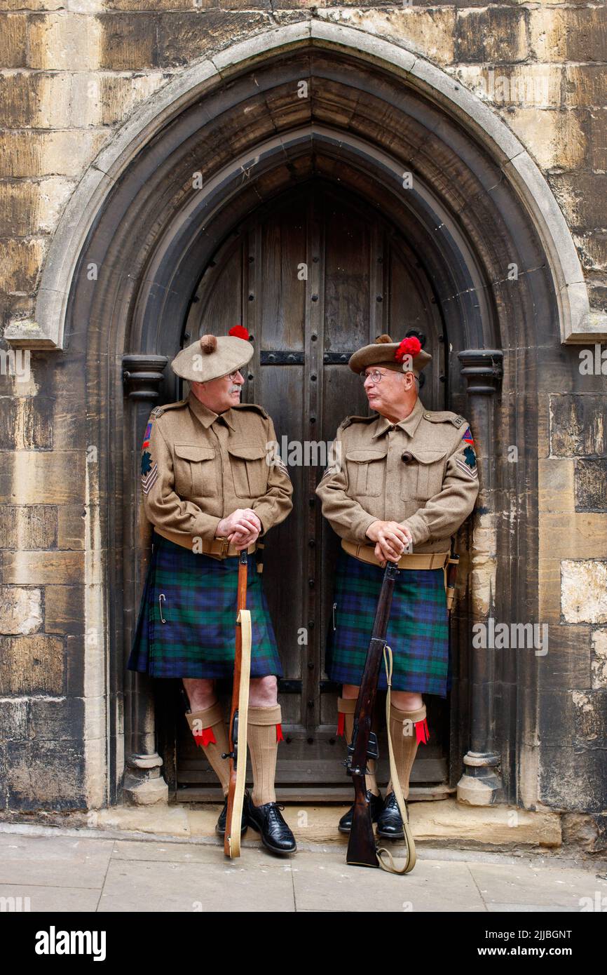 Lincoln 1940's festival held in the up Hill Bailgate area of the city near the Castle and the Cathedral. Two men dressed identically in period costume pose in a church doorway in Bailgate. Stock Photo