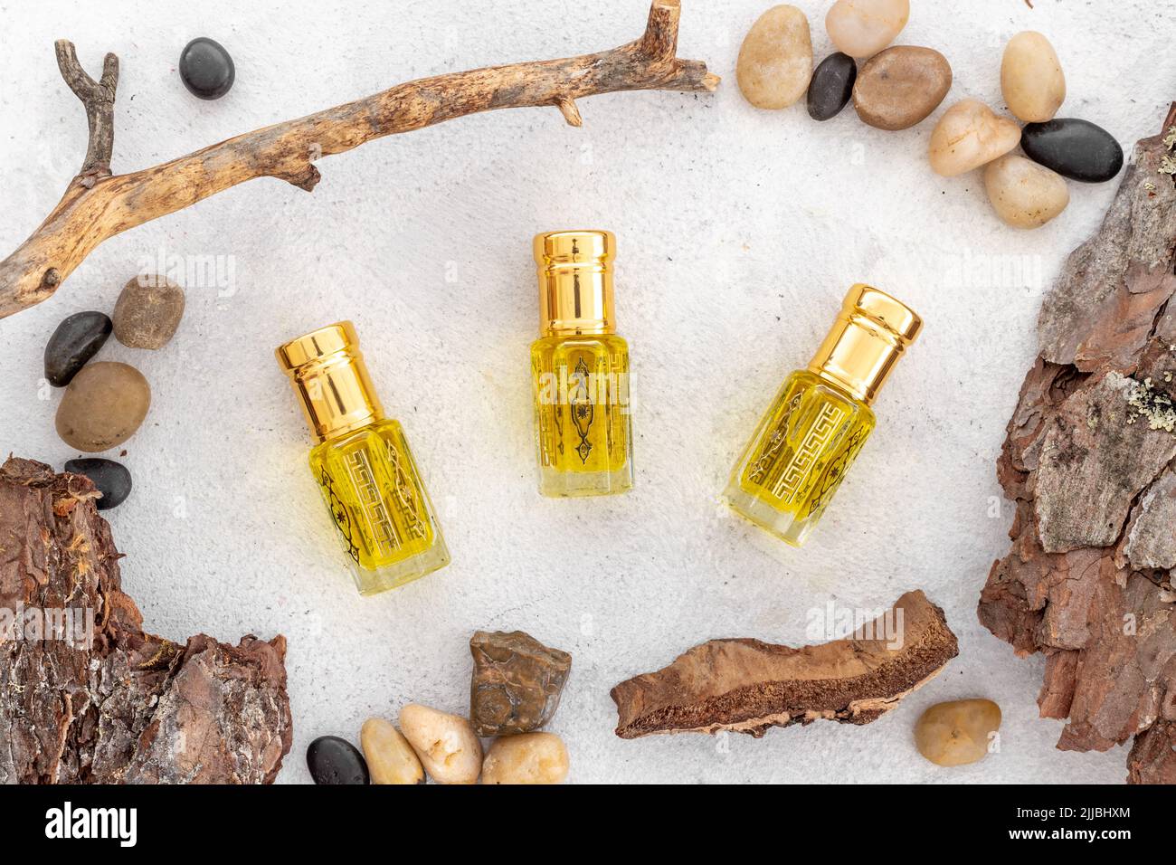 Arabian oud attar perfume essential oil in glass bottles, top view