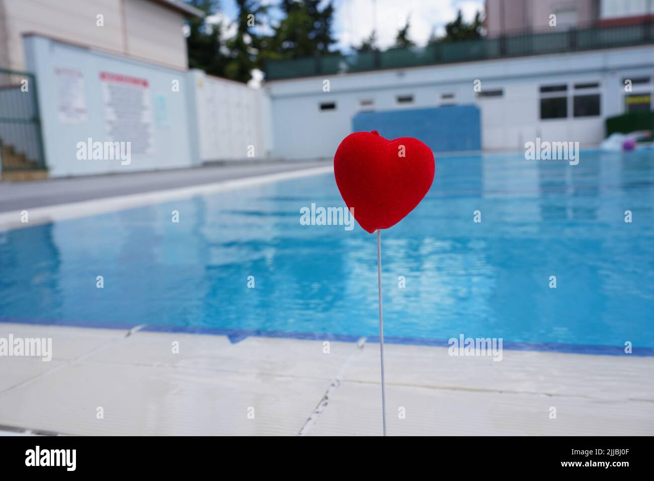 Picture of wet red heart by the pool. Valentine's Day love heart nature ...